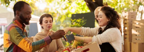 people exchanging goods at farmers market